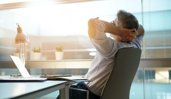 Businessman in office relaxing in chair